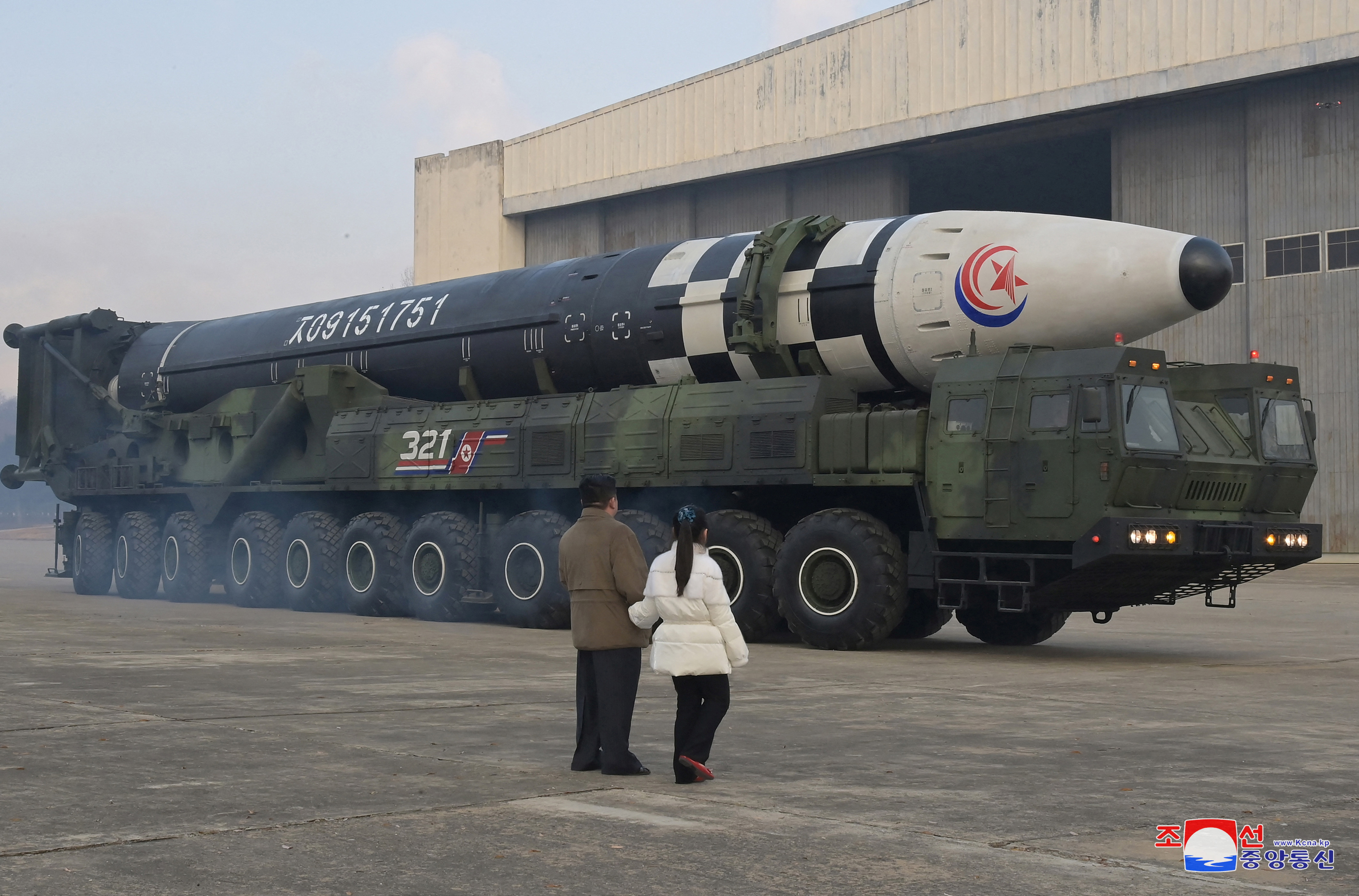 North Korean leader Kim Jong Un, along with his daughter, inspects an intercontinental ballistic missile in this undated photo released on November 19, 2022.