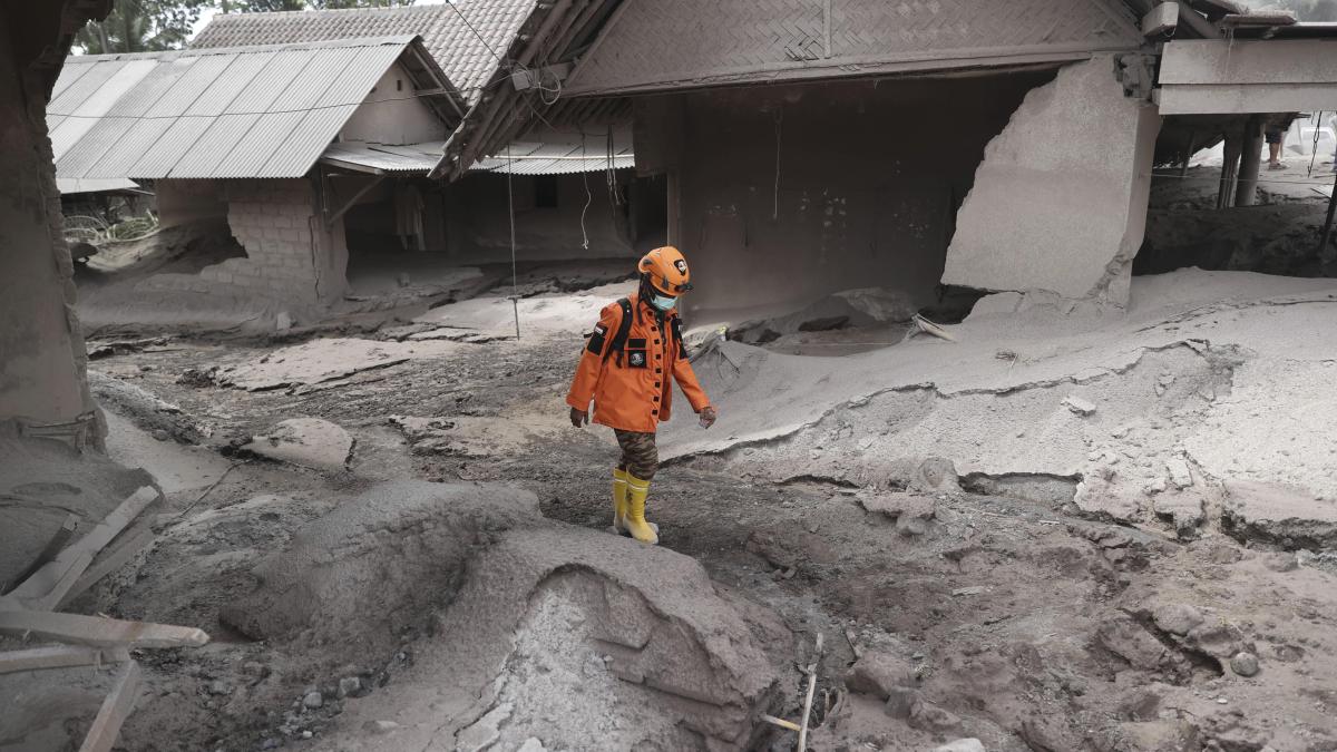 A rescuer walks through an area hit by the eruption of Mount Semeru in Lumajang district, East Java province, Indonesia.