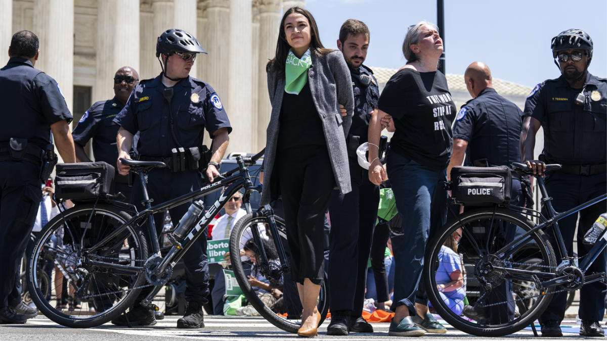 At least 17 House Democrats, including Alexandria Ocasio-Cortez (pictured, centre) were arrested while protesting otuside the Supreme Court on Tuesday over the recent overturning of the Roe v. Wade ruling on abortion rights.
