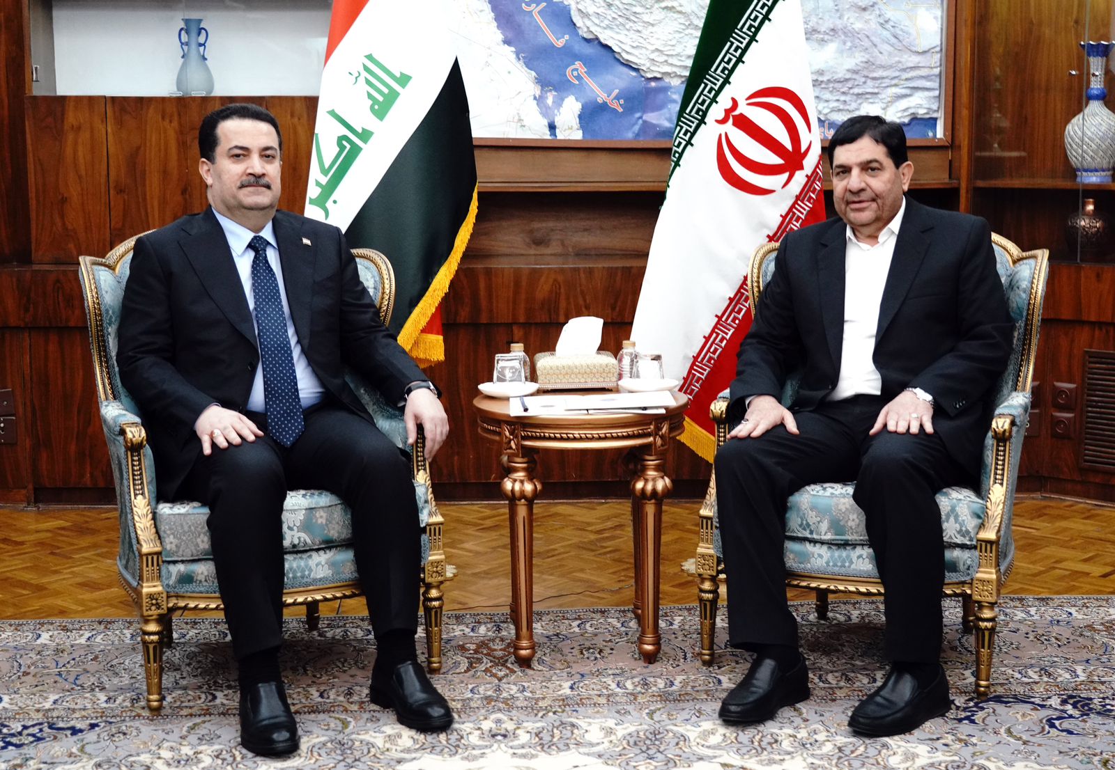 Iranian Vice President Mohammad Mokhber (R) and Iraqi PM Mohammed Shia Al-Sudani
